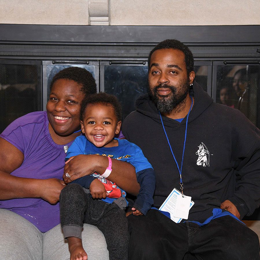 family posing together at the house