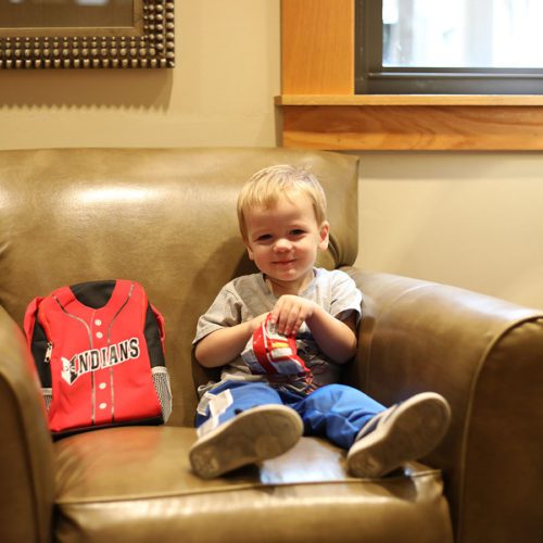 child sitting in large chair