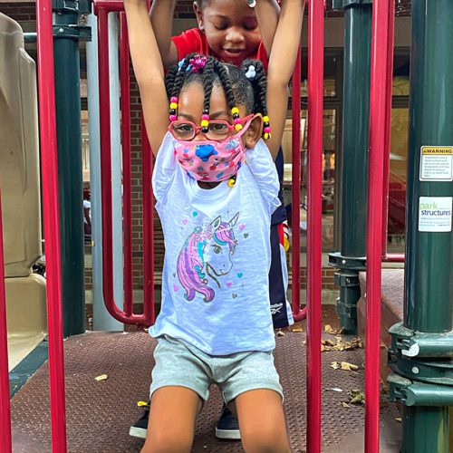 child playing on jungle gym