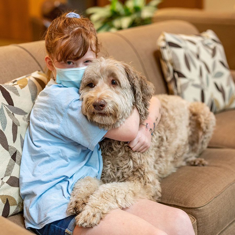 child resting with mac the dog on the couch