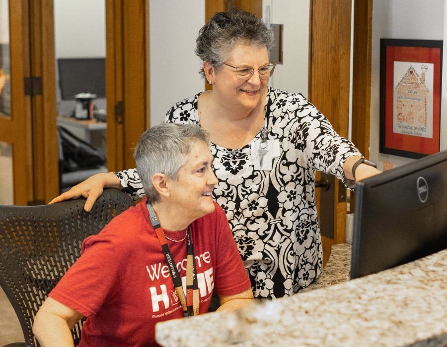 mary friend with volunteer on computer