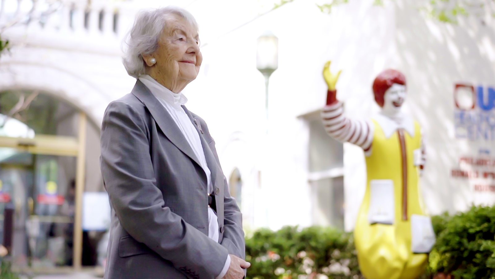 Dr. Evans smiles, with Ronald McDonald statue in background