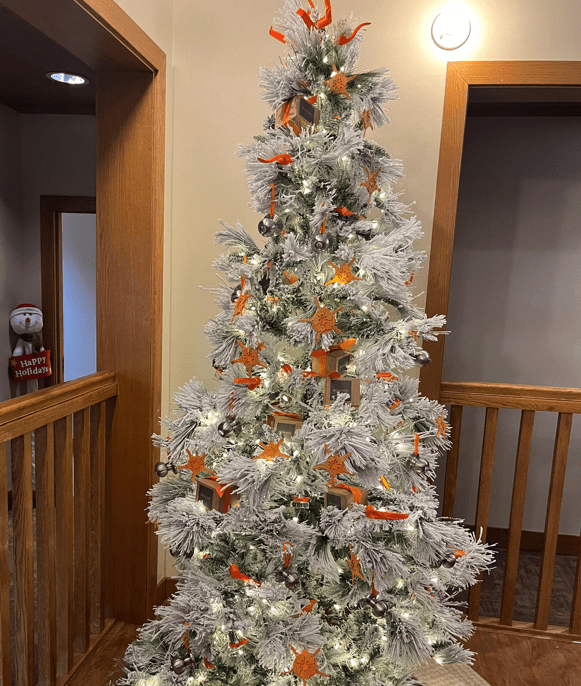 Christmas tree with white snow, decorated with door knobs and keys