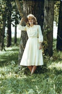 Lori Kleiman poses by a tree